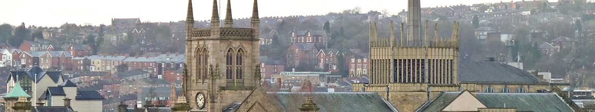 Blackburn Cathedral from the canal towpath; railway station roof in the foreground United Kingdom